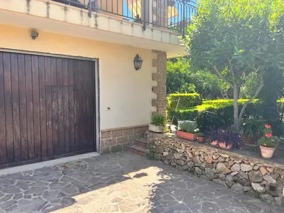 a house with a wooden door and a stone wall at IL Rustico di Giò in Carini