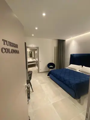 a bedroom with a blue bed in a room at IL DUCA HOUSE e HOLIDAY PRESTIGE in Caccamo