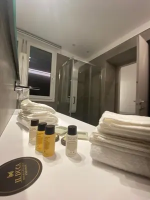 a bathroom with three bottles of essential oils on a counter at IL DUCA HOUSE e HOLIDAY PRESTIGE in Caccamo