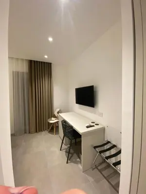 a room with a desk and a tv on a wall at IL DUCA HOUSE e HOLIDAY PRESTIGE in Caccamo