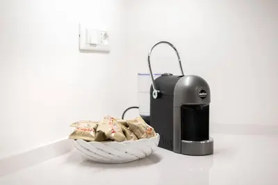 a basket of clothes next to a heater on a counter at Casa di Dada - statua in Palermo