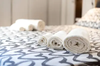 a group of rolled towels on a bed at Casa di Dada - statua in Palermo