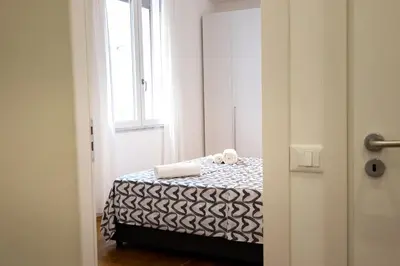 a bedroom with a bed with black and white sheets at Casa di Dada - statua in Palermo