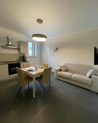 a living room with a couch and a table with chairs at Marosa Casa Vacanze in Torretta