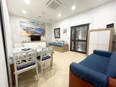 a living room with a blue couch and a table at Domus Rosaliae - Casa Vacanze in Palermo