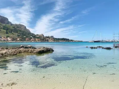 a view of a beach with rocks in the water at Domus Rosaliae - Casa Vacanze in Palermo