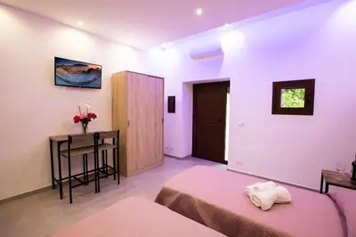 a bedroom with a bed and a table and a desk at La Domus di Segesta 