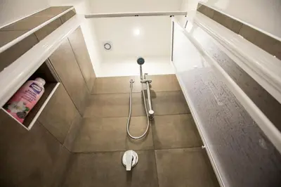 a bathroom with a shower with a glass door at La Domus di Segesta 
