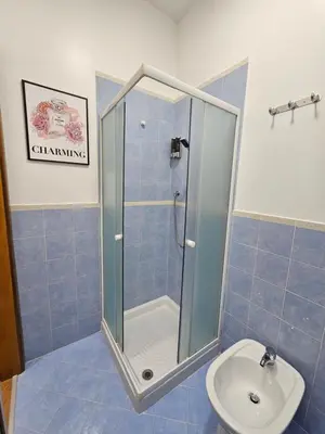 a bathroom with a shower and a toilet and a sink at LA CASA DI VIOLA in Palermo