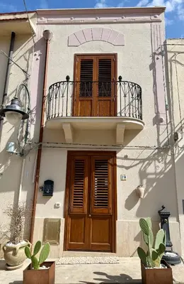 a door of a house with pink flowers on it at Castello a Mare in Castellammare del Golfo