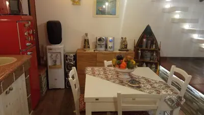a kitchen with a table with a bowl of fruit on it at Al Vicoletto Boutique in Castellammare del Golfo