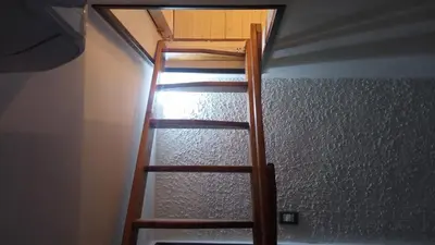 a wooden ladder in a room with a ceiling at Al Vicoletto Boutique in Castellammare del Golfo