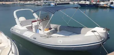 a white boat is docked in the water at Mami Holiday House in Castellammare del Golfo