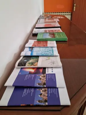 a row of books sitting on top of a table at Casa di Mamma in Godrano