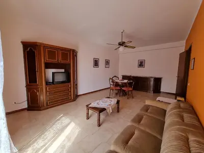 a living room with a couch and a tv and a table at Casa di Mamma in Godrano