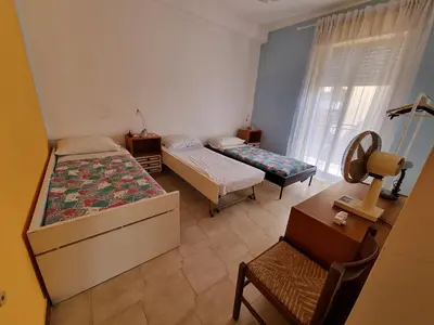 a bedroom with two beds and a desk and a chair at Casa di Mamma in Godrano