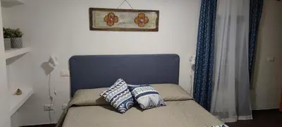 a bed with two pillows on it in a room at Le Casette in Palermo