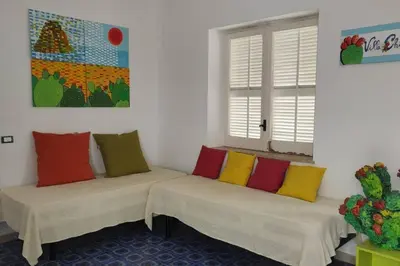 two beds in a room with colorful pillows on them at VILLA CHIARA 200 MT DA MARE SPIAGGIA LIBERA SABBIA in Capaci
