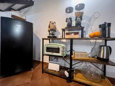 a room with a tv and a microwave on a shelf at Domus Conte Federico in Palermo