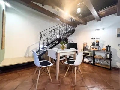 a dining room with a white table and chairs at Domus Conte Federico in Palermo