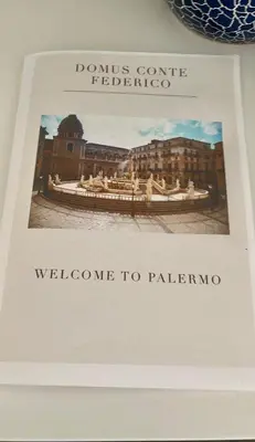 a book with the words welcome to palenino at Domus Conte Federico in Palermo