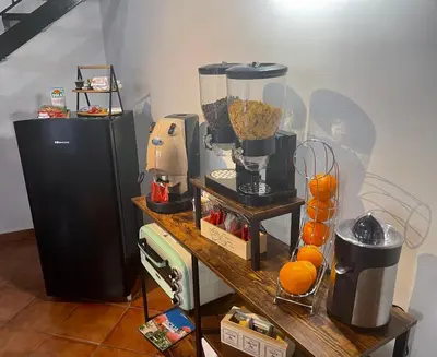 a counter with a blender and oranges on it at Domus Conte Federico in Palermo