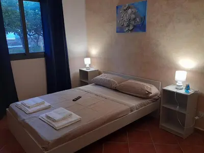 a bedroom with a bed with two towels on it at La Cycas in Trabia