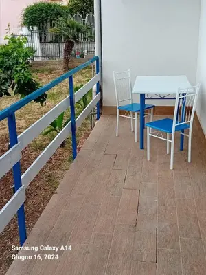 a table and chairs sitting on a porch at La Cycas in Trabia