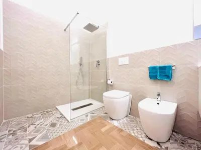 a bathroom with a toilet and a shower at Villa di Nera Apartments in Palermo