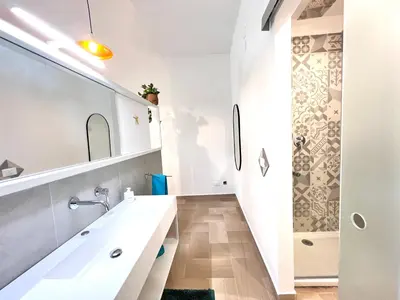 a white bathroom with a sink and a shower at Villa di Nera Apartments in Palermo