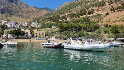 a group of boats docked in a body of water at Hotel Cala Marina in Castellammare del Golfo