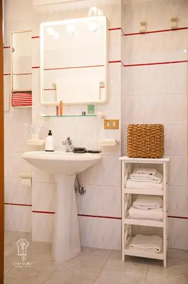 a white bathroom with a sink and a mirror at CIATU ME' Brezza Marina in Castellammare del Golfo