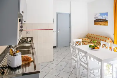 a kitchen and living room with a table and chairs at CIATU ME' Brezza Marina in Castellammare del Golfo
