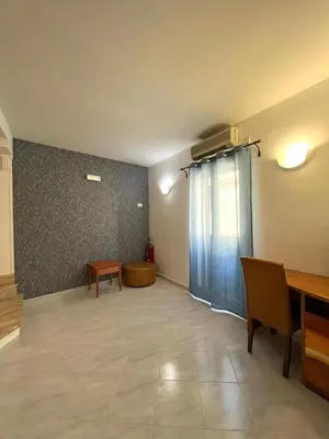 a living room with a desk and a table at Hotel d'Orleans in Palermo