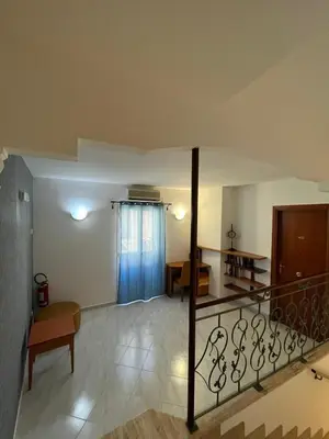 a living room with a staircase leading to a room at Hotel d'Orleans in Palermo