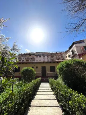 a building with a pathway in front of it at Hotel d'Orleans in Palermo