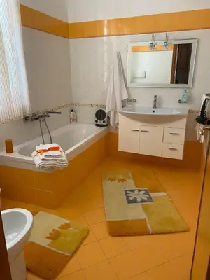 a bathroom with a tub and a sink and a toilet at Holiday mode EVA in Partinico