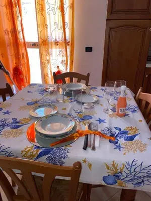 a table with plates and glasses on top of it at Holiday mode EVA in Partinico