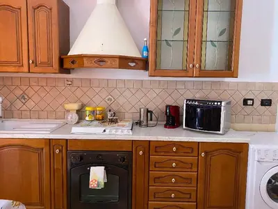 a kitchen with a sink and a stove top oven at Holiday mode EVA in Partinico