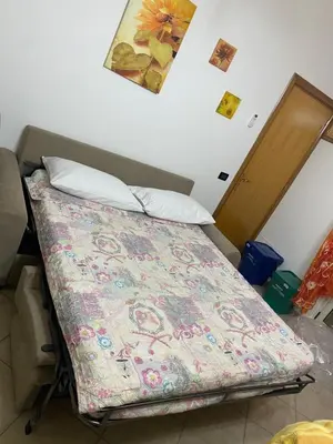 a bed in a room with a blanket on it at Holiday mode EVA in Partinico