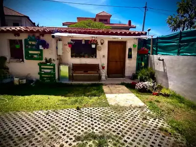 a small white house with a door and a yard at Appartamento Green Room in Palermo