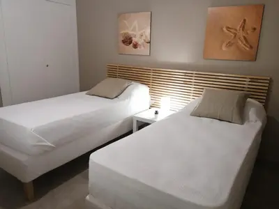 two beds in a small room with acknowled at Appartamento Corallo in San Vito lo Capo