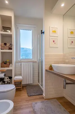 a bathroom with a tub and a sink and a window at La Paperella Blu Apartment in Termini Imerese