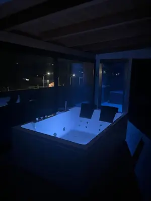 a dark room with a bath tub with two chairs at Casa Vacanza Accetta in Trappeto