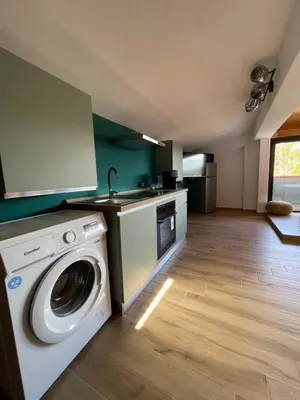 a kitchen with a washing machine and a sink at Casa Vacanza Accetta in Trappeto