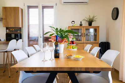 a dining room table with wine glasses and food on it at Villa Arianna, il piacere di vivere nella natura. in Alcamo