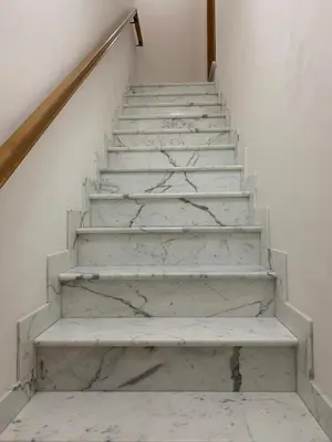 a stairway with white marble floors and white walls at Casa Katrin & Casa Brigida in Castellammare del Golfo