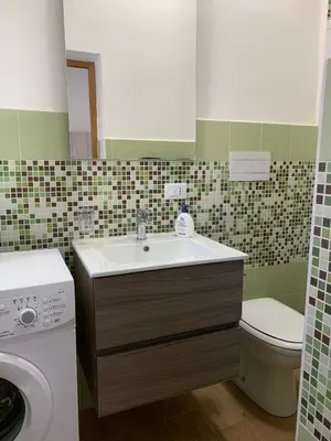 a bathroom with a sink and a toilet at Casa Katrin & Casa Brigida in Castellammare del Golfo