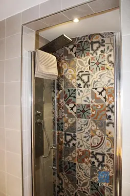 a bathroom with a shower with a mirror at Carducci Loft in Castellammare del Golfo