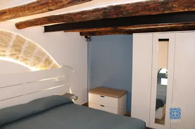 a bedroom with a bed and a mirror at Carducci Loft in Castellammare del Golfo